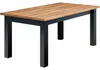 A rectangular dining table with a wooden top and black legs, presented on a white background. Produktbild-Vorschau