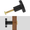 A knob and screw assembly and the same knob installed on a wooden surface. Produktbild-Vorschau