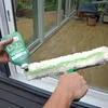 A person is cleaning a window with a cleaning set. Produktbild-Vorschau