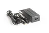 A black power adapter with two cables on a white background. Náhľad obrázku produktu