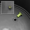 A close-up view of a gray plastic surface, likely a planter or container, showing a green plug and a brass fitting. Produktbild-Vorschau