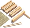 A set of bamboo sushi-making tools, including a rolling mat, a rolling press, and chopsticks, arranged on a white background. Náhľad obrázku produktu