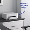 A white Epson WorkForce Pro WF-M4119DW printer is placed on a dark countertop, which is on top of a white cabinet. The background is a light gray wall. Náhľad obrázku produktu