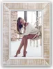A woman sits in a hanging chair in a room with brick walls and a white carpet. Anteprima dell’immagine prodotto