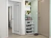 A hallway with a shoe rack, a door, and a wall with plant-themed wallpaper. Podgląd zdjęcia produktu