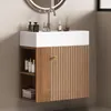 A bathroom vanity with a sink and cabinet. Voir les images du produit