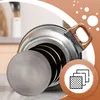 A close-up of a stainless steel pot with a brown handle, set against a light background with decorative circles and a kitchen scene in the background. A circular icon with stacked squares is visible in the lower right corner. Náhled obrázku produktu