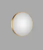 A round mirror with a gold frame against a gray background. Náhled obrázku produktu
