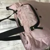 Close-up of a pink shopping roller bag with black straps and trim. Produktbild-Vorschau