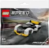 A LEGO Speed Champions McLaren Solus GT polybag on a blurred racetrack background. Náhľad obrázku produktu