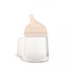 A baby bottle with a peach-colored nipple and cap, shown against a white background. Anteprima dell’immagine prodotto