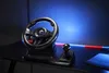 A gaming steering wheel and gear shifter are set up on a desk with blue and red LED lighting in the background. Anteprima dell’immagine prodotto