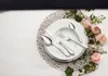 A table setting with plates, cutlery, and floral decorations. Produktbild-Vorschau