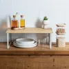 A kitchen shelf with storage containers, plates, and bottles. Podgląd zdjęcia produktu