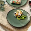 A table setting with plates of spring rolls and edamame. Produktbild-Vorschau
