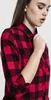 Close-up of a woman wearing a red and black checkered flannel shirt. Náhled obrázku produktu