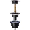 An exploded view of a black drain assembly with brass internal components against a white background. Náhľad obrázku produktu