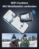 A smartphone displaying a live preview from an action camera, with the action camera itself shown next to it. Below, two people in ski gear are shown in a snowy mountain landscape. Produktbild-Vorschau