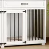 A close-up view of a white dog crate with black bars and a wooden top. Produktbild-Vorschau