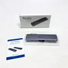 The image shows a USB C hub and its packaging, along with a user manual, arranged on a white surface. Produktbild-Vorschau