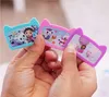 Hands holding three cat-shaped toy cameras with cartoon characters on the screens. Produktbild-Vorschau