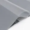 A close-up, studio shot of a folded grey roller blind with a sheer white striped section. Produktbild-Vorschau