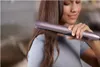 A woman is straightening her hair with a hair straightener. Voir les images du produit