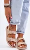 A close-up shot of a person's feet wearing beige sandals. Produktbild-Vorschau