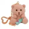 A small pink teddy bear keychain holding a baby bottle. Anteprima dell’immagine prodotto
