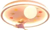 A ceiling light fixture with a cartoon theme, featuring a girl figure and celestial elements. Produktbild-Vorschau
