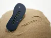 A flip-flop is placed on a pile of sand, with its imprint visible in the sand. Produktbild-Vorschau