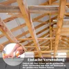 Close-up of hands cutting insulation material with scissors, with a background of wooden roof beams. Náhled obrázku produktu