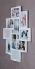 A white multi-photo frame collage mounted on a textured gray wall. Produktbild-Vorschau