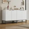 A modern white sideboard with fluted doors sits on a dark metal frame, placed on a wooden floor. The wall behind has decorative architectural elements and artwork. Anteprima dell’immagine prodotto