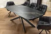A dining table with chairs in a room. Produktbild-Vorschau