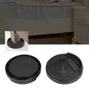 A close-up view of black furniture leg pads, with a smaller inset image showing one pad under a furniture leg. Podgląd zdjęcia produktu