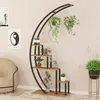 A modern plant stand with multiple shelves, displaying various potted plants in a room setting. Produktbild-Vorschau