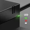 Close-up of a black power adapter with a green LED light illuminated. Podgląd zdjęcia produktu