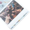 A family lying on the grass, holding hands, with a child in the center. Anteprima dell’immagine prodotto