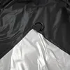 A close-up view of the corner of a black and silver tarp or cover, showing a metal D-ring attached with webbing. Anteprima dell’immagine prodotto