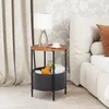 A bedside table with a lamp and a cup of coffee next to a bed. Náhled obrázku produktu