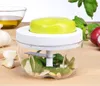 A manual food chopper with basil, pine nuts, and garlic on a wooden surface. Produktbild-Vorschau