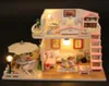 A miniature dollhouse with furniture and lights. Podgląd zdjęcia produktu