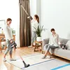 Three women are shown cleaning their house with a cordless vacuum cleaner. Produktbild-Vorschau