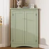 A green corner cabinet with two doors is shown in a room setting. Produktbild-Vorschau