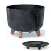A black planter with a marbled pattern sits on three copper-colored legs, with a separate black saucer shown below. Produktbild-Vorschau
