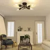 A living room scene with a fireplace, armchair, coffee table, and a ceiling light. Voir les images du produit