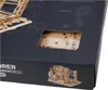 Close-up of a product box for a Robotime Marble Explorer kit, showing a cutout revealing some of the wooden components inside and a small illustration of the assembled product on the front. Produktbild-Vorschau