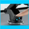 A close-up shot of a finger pressing down on a car phone mount suction cup. Produktbild-Vorschau