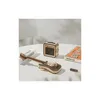 A wooden model of an electric guitar and a miniature amplifier are displayed on a white surface, with a book in the background. Voir les images du produit
